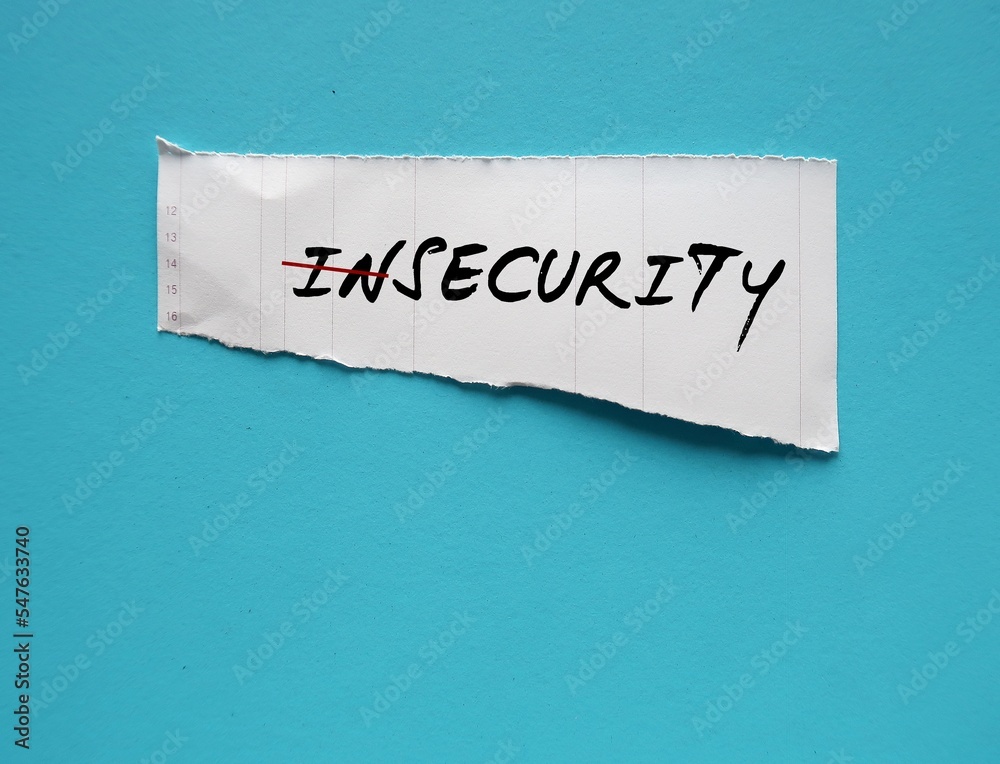 Torn paper on blue copy space background with handwriting INSECURITY ...