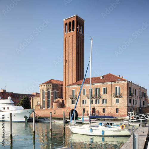 Isola di Sant' Elena, Venezia. Chiesa omonima con campanile e darsena con barche photo