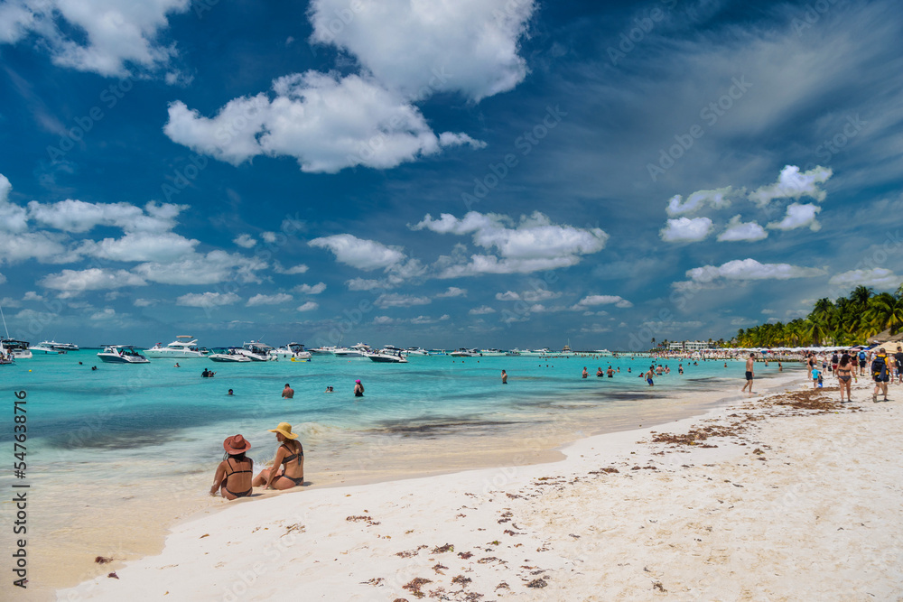 2 sexy girls ladies are sitting in brazilian string bikini on a white sand beach, turquoise caribbean sea, Isla Mujeres island, Caribbean Sea, Cancun, Yucatan, Mexico