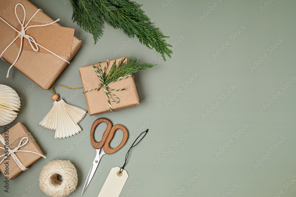Christmas background with gift boxes and kraft wrapping paper. Xmas celebration, preparation for winter holidays. Festive mockup, top view, flatlay - obrazy, fototapety, plakaty 