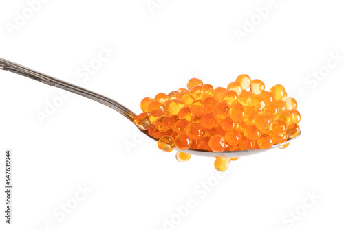 Red caviar in the silver spoon isolated on a white background. Trout or salmon caviar close up. Macro shot.