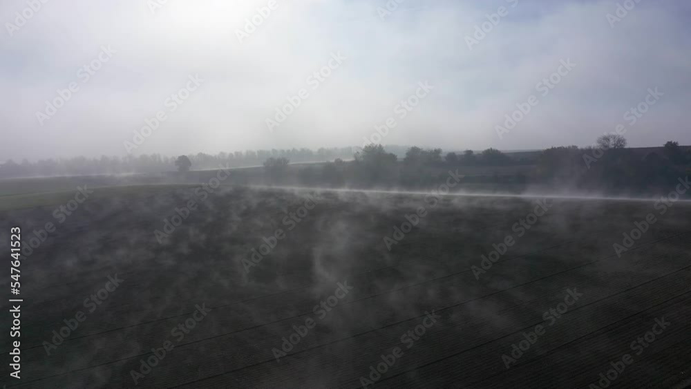 Flying Through Scattered Wispy Clouds Over Plains In Countryside. Aerial Drone Shot