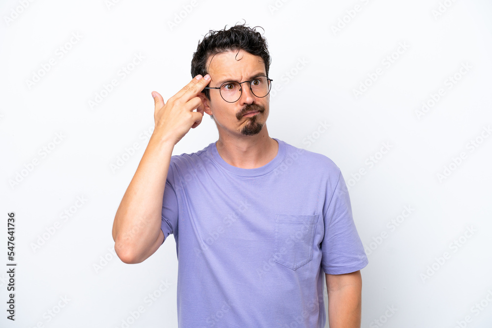 Fototapeta premium Young man with moustache isolated on white background with problems making suicide gesture
