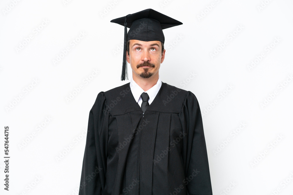 Young university graduate man isolated on white background and looking up Young university graduate man isolated on white background and looking up