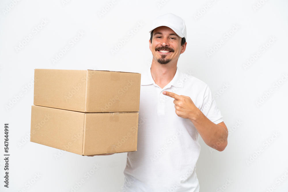 Delivery caucasian man isolated on white background pointing to the side to present a product Delivery caucasian man isolated on white background pointing to the side to present a product