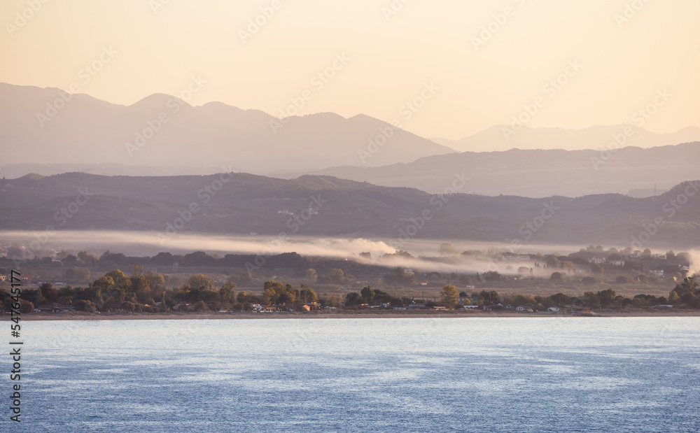 Residential Homes by the beach on Ionian Sea in a small touristic Town. Katakolo, Greece. Twilight Sunrise Sky.