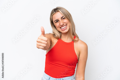 Young caucasian woman isolated on white background with thumbs up because something good has happened