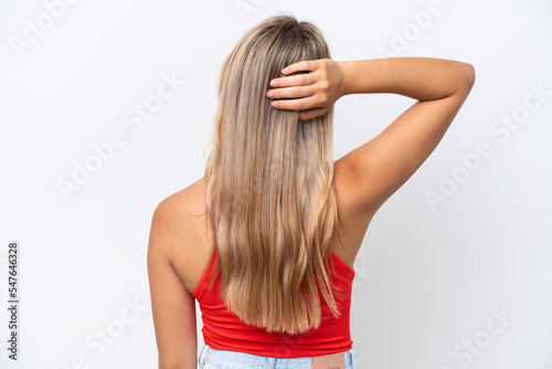 Young caucasian woman isolated on white background in back position and thinking