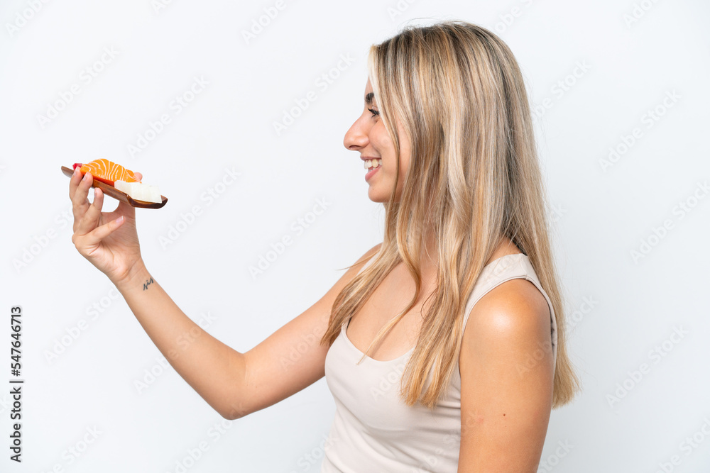Young caucasian woman holding sashimi isolated on white background with happy expression Young caucasian woman holding sashimi isolated on white background with happy expression