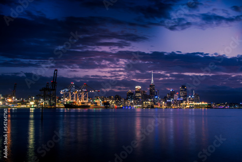 Bright lights of Auckland downtown at night. Dramatic view over Auckland City from North Shore © Irina B
