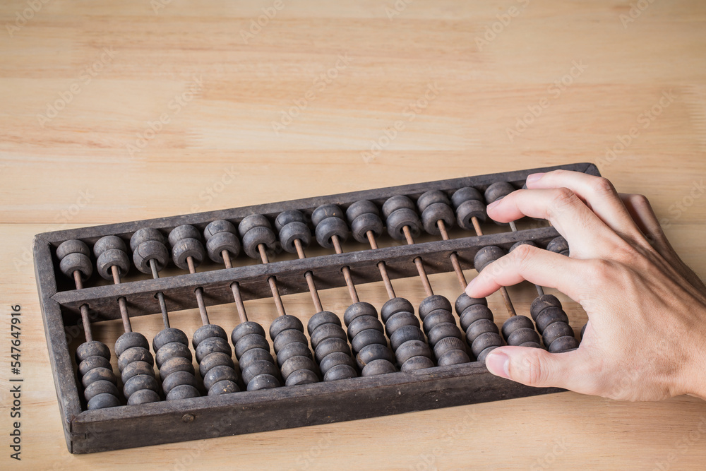 Chinese traditional calculator, old abacus on wooden backgroun Chinese traditional calculator, old abacus on wooden backgroun