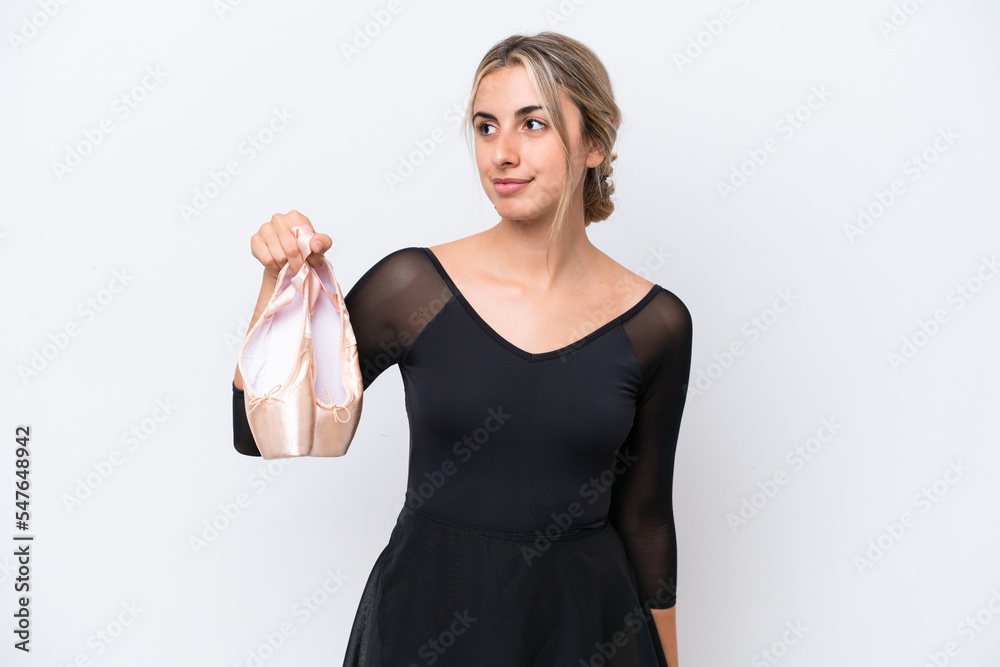 Young caucasian woman practicing ballet isolated on white background looking to the side Young caucasian woman practicing ballet isolated on white background looking to the side