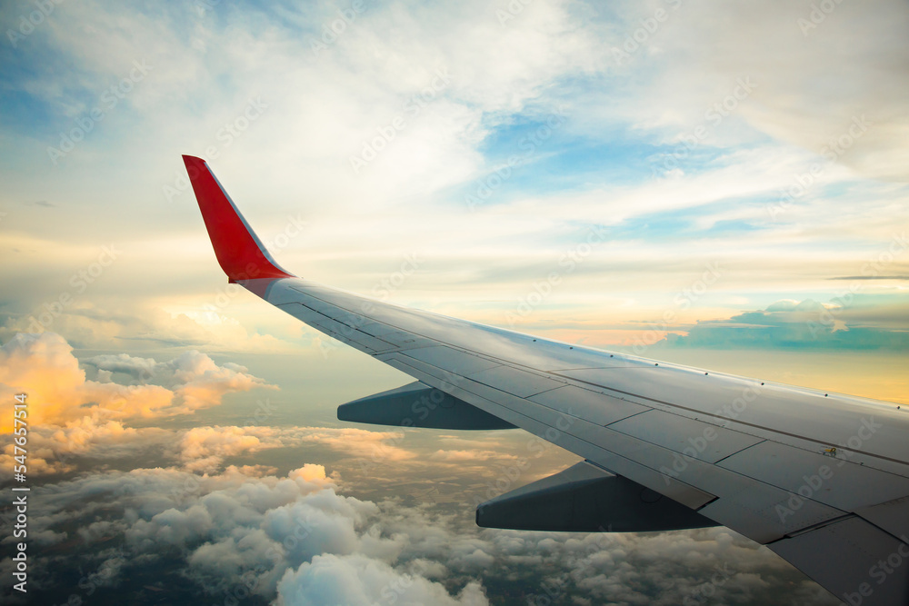 Morning sunrise with Wing of an airplane. Photo applied to tourism operators. picture for add text message or frame website. Traveling concept Morning sunrise with Wing of an airplane. Photo applied to tourism operators. picture for add text message or frame website. Traveling concept