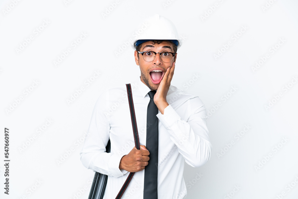 Architect brazilian man with helmet and holding blueprints with surprise and shocked facial expression Architect brazilian man with helmet and holding blueprints with surprise and shocked facial expression