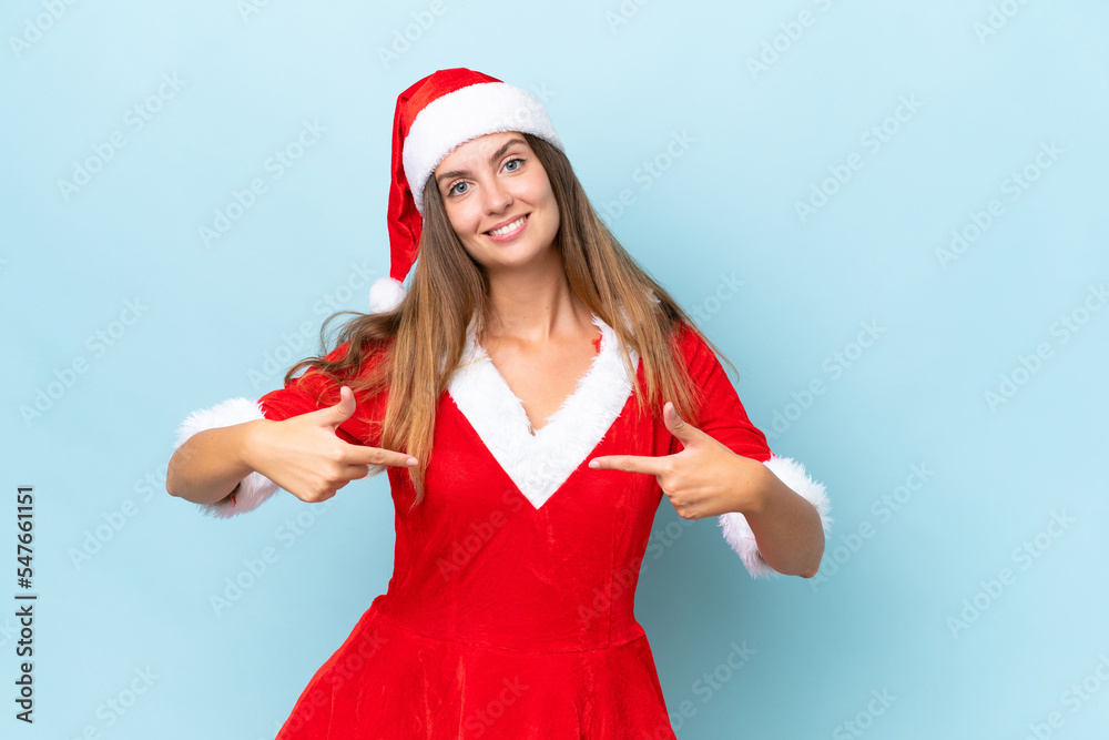 Young caucasian woman dressed as mama noel isolated on blue background proud and self-satisfied Young caucasian woman dressed as mama noel isolated on blue background proud and self-satisfied