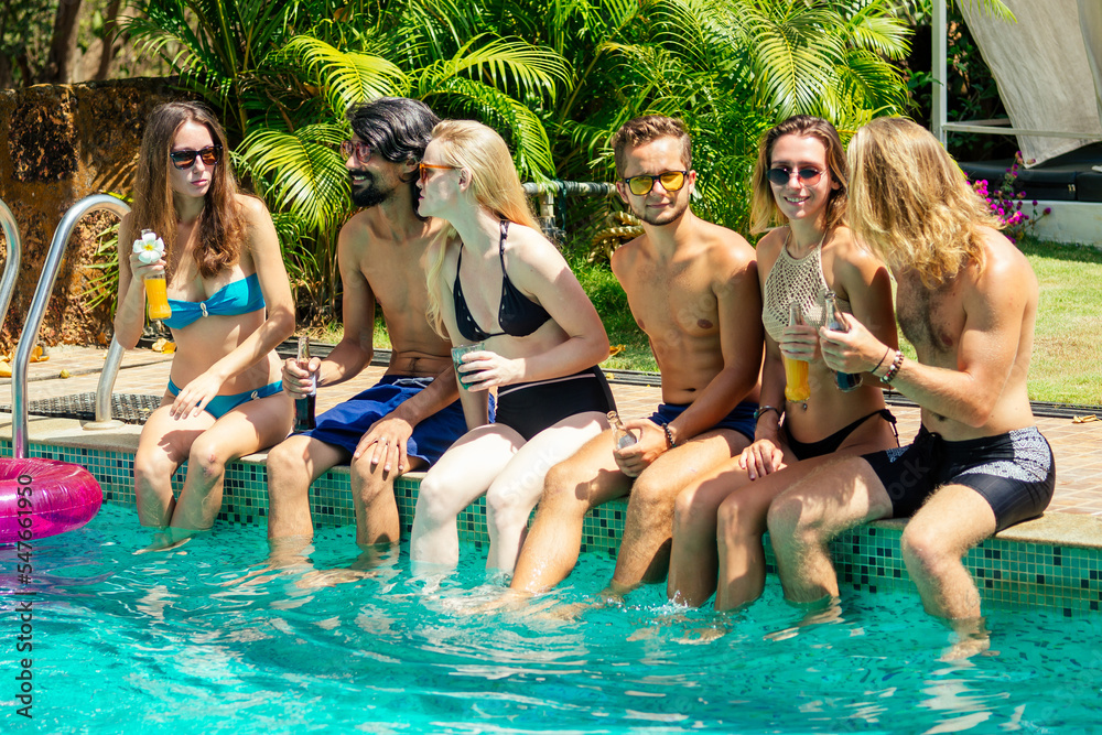 best friends drinking lemonade while refreshing in the swimmingpool