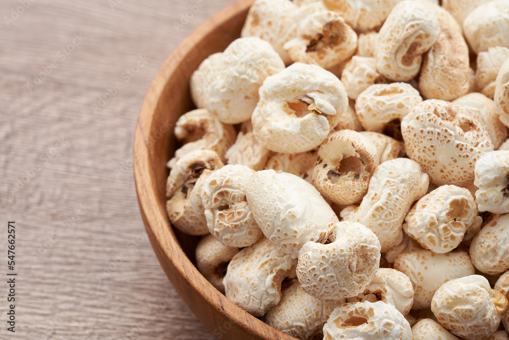 traditional Korean popcorn or Gangnange in wood bowl on wooden table background traditional Korean popcorn or Gangnange in wood bowl on wooden table background