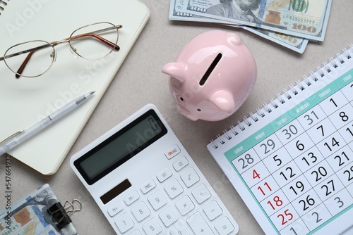 Flat lay composition with piggy bank and calculator on light grey background
