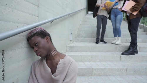 A group of students harass a young student at the university