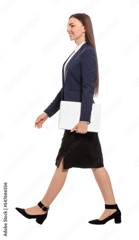 Young businesswoman with laptop walking on white background Young businesswoman with laptop walking on white background