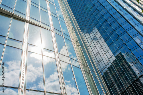 Beautiful buildings with many windows near cloudy sky