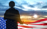 USA army soldier on a background of sunset and USA flag. USA armed forces. National holidays concept
