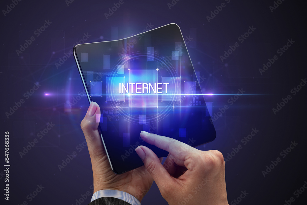 Businessman holding a foldable smartphone Businessman holding a foldable smartphone