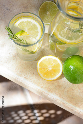 Tasty refreshing lemonade and ingredients on light table, above view. Space for text © New Africa