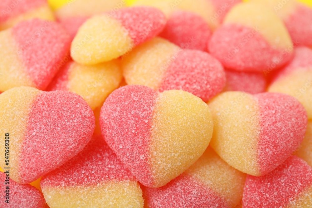 Many tasty jelly candies in shape of hearts as background, closeup Many tasty jelly candies in shape of hearts as background, closeup