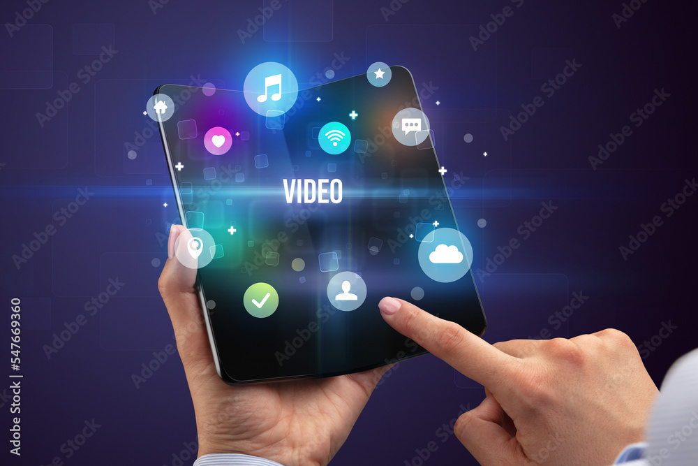Businessman holding a foldable smartphone Businessman holding a foldable smartphone