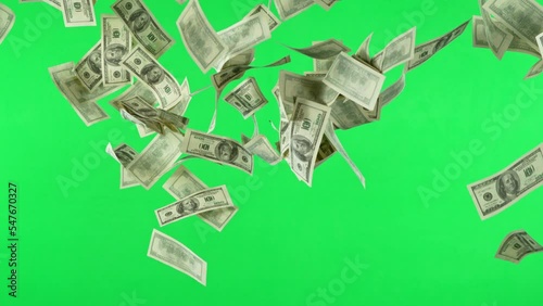Super slow motion of flying US dollars banknotes on green background. Filmed on high speed cinema camera, 1000fps. Isolated on green screen, ready for background change.