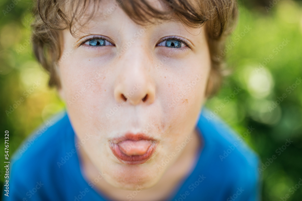 face portrait boy grimace, showing tongue face portrait boy grimace, showing tongue