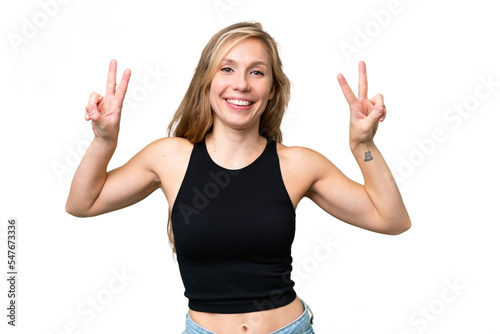 Young blonde woman over isolated background showing victory sign with both hands