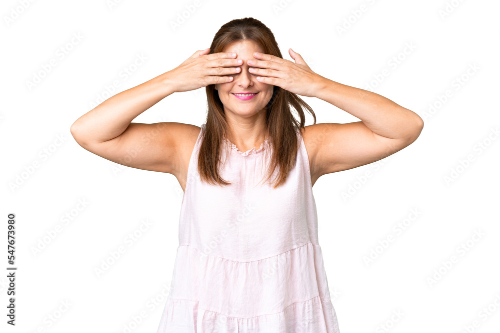 Middle age woman over isolated background covering eyes by hands and smiling Middle age woman over isolated background covering eyes by hands and smiling