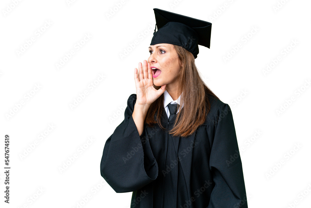 Middle age university graduate woman over isolated background shouting with mouth wide open to the lateral Middle age university graduate woman over isolated background shouting with mouth wide open to the lateral