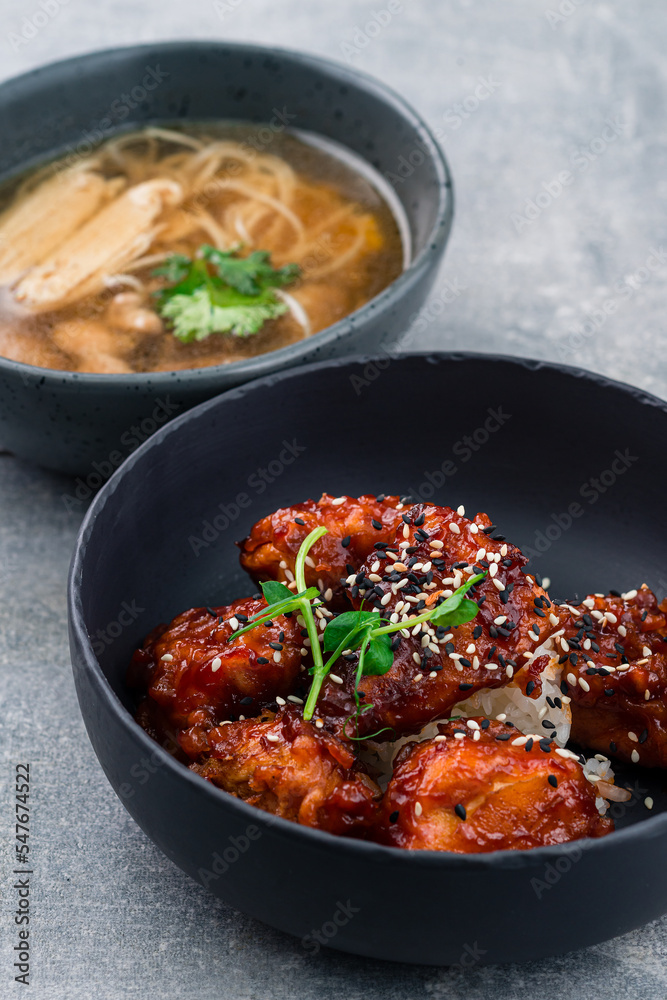 Lunch fried chicken in unagi sauce and broth with noodles and chicken in bowls Lunch fried chicken in unagi sauce and broth with noodles and chicken in bowls
