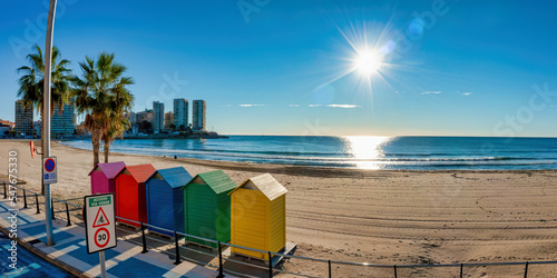 Five colorful little beach huts at the beach in Oropesa del Mar, Spain