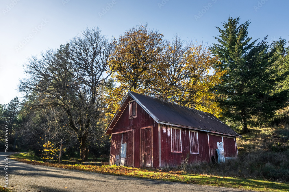 Abandoned red shed with yellow trees behind it, in Penhas Douradas, Serra da Estrela, Portugal. Abandoned red shed with yellow trees behind it, in Penhas Douradas, Serra da Estrela, Portugal.