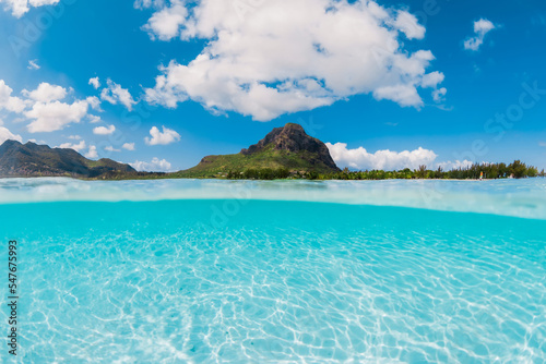 Ocean with transparent water and Le Morne mountain in Mauritius. Fifty fifty view.