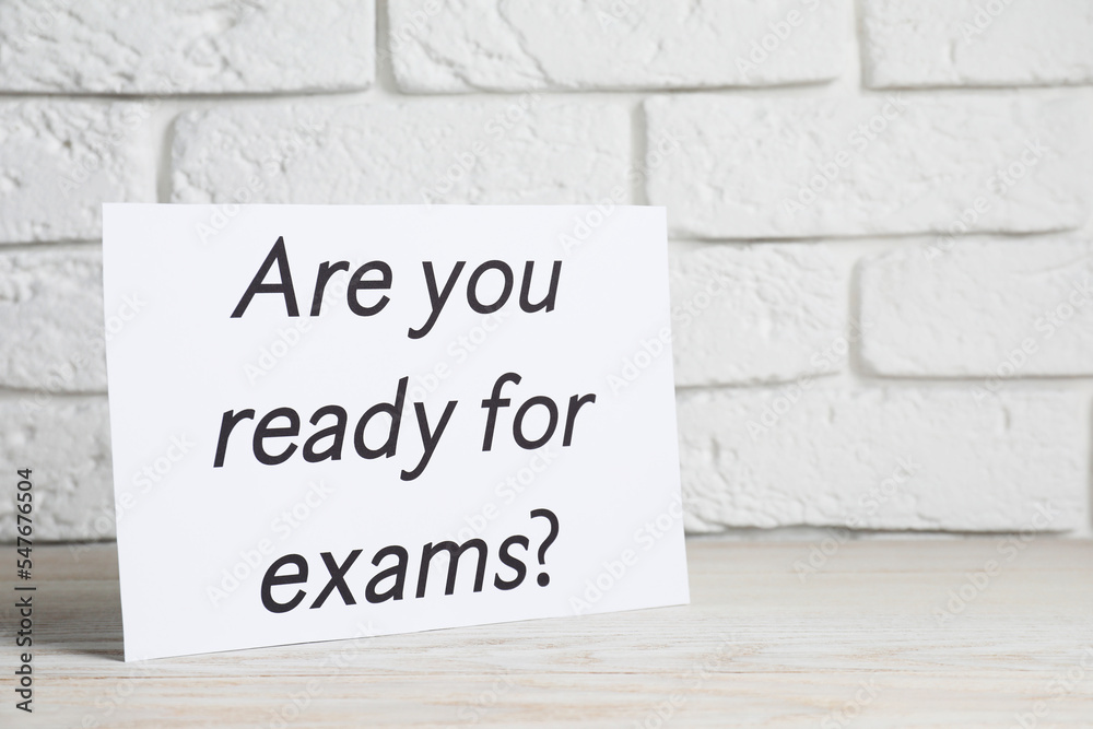 Obraz premium Paper with question Are you ready for exams on white wooden table