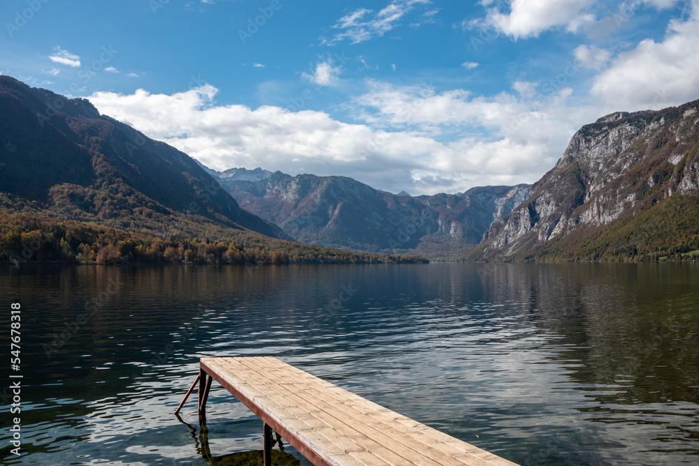 Scenic view of a small wooden jetty at lake Bohinj in the Triglav National Park, The Julian Alps of Slovenia Scenic view of a small wooden jetty at lake Bohinj in the Triglav National Park, The Julian Alps of Slovenia