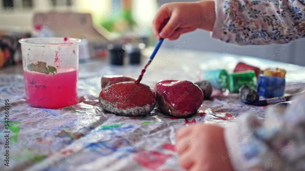 Cute Creative Gifted Caucasian Child Painting Rock with Colorful Poster Paint