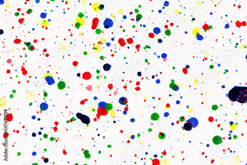 Paint splatters on bright material. Watercolor on white paper.