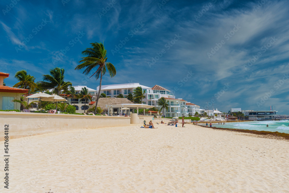 Sandy beach on a sunny day with hotels in Playa del Carmen, Mexico