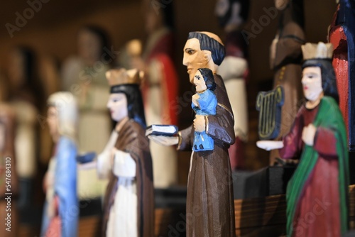 Selective focus shot of Christian statues, a siant holding baby photo