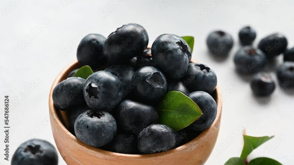 Blueberries berry in wooden bowl, on bright background. Healthy food template, mock up with copy space. Blueberries berry in wooden bowl, on bright background. Healthy food template, mock up with copy space.