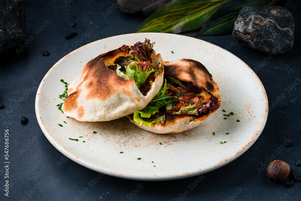 Pita with sweet and sour fried chicken, arugula, lettuce and greens. Pita with sweet and sour fried chicken, arugula, lettuce and greens.