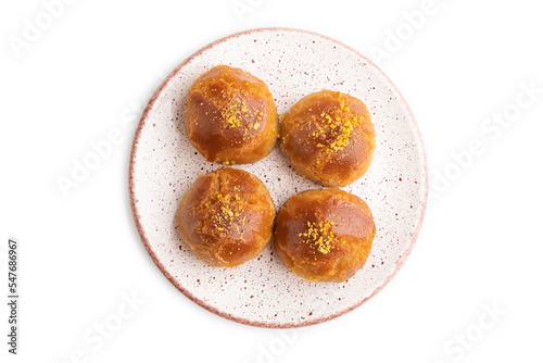 Traditional turkish dessert sekerpare with almonds and honey isolated on white, top view.