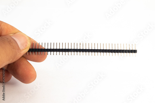 A header module of the jumper is held in hand. This module is used for electronics hobbyists for DIY materials.