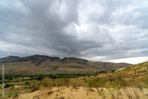 Sand dunes Sarykum in Dagestan with gray clouds